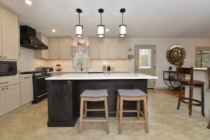 kitchen island with black lower cabinets and white upper cabinets